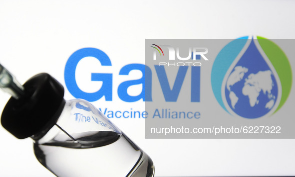 A medical syringe and a vial in front of the GAVI the Vaccine Alliance logo are seen in this creative illustrative photo. More than one hund...