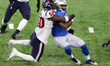 Detroit Lions running back Adrian Peterson (28) is tackled by Houston Texans linebacker Ty...