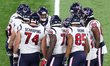 Houston Texans players discuss a play in the huddle during the second half of an NFL footb...