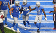 Detroit Lions wide receiver Mohamed Sanu (12) is congratulated by Detroit Lions offensive...