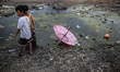 Children play at a slum area in Jakarta on 29 November, 2020. Indonesia’s economy is expec...