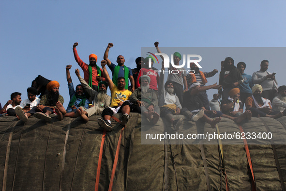 Farmers shout slogans during a protest against the Centre's new farm laws at Singhu border near Delhi, India on November 30, 2020. Farmers f...