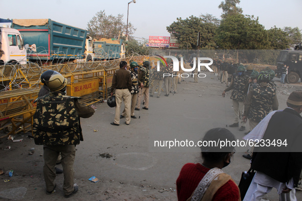 Security personnel deployed to stop farmers from entering the national capital during a protest against the Centre's new farm laws at Singhu...