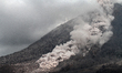 Bursts of smoke spews volcanic ash after the Sinabung volcano alert level raised to highes...