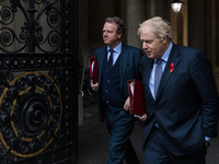 British Prime Minister Boris Johnson (R) and Secretary of State for Scotland Alister Jack (L) return to Downing Street in central London aft...