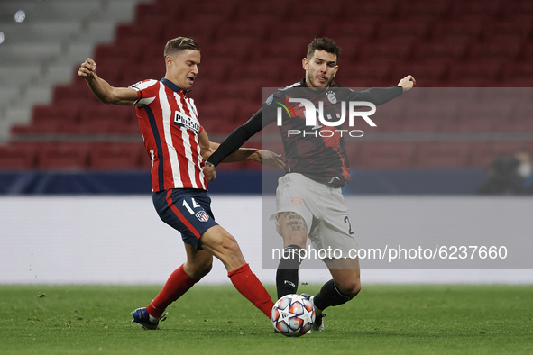 Marcos Llorente of Atletico Madrid  and Lucas Hernandez of Bayern compete for the ball during the UEFA Champions League Group A stage match...