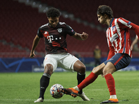 Joao Felix of Atletico Madrid and Serge Gnabry of Bayern compete for the ball during the UEFA Champions League Group A stage match between A...