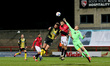 Mark Halstead of Morecambe punches clear under pressure from Barrow's Scott Quigley during...