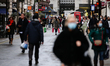 Shoppers, some wearing face masks, carry bags along Argyll Street in London, England, on D...
