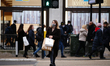 A shopper wearing a face mask crosses Oxford Circus in London, England, on December 4, 202...