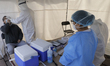 Medical personnel carry out new rapid tests for COVID-19 antigens at a health mega kiosk l...