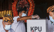 Balinese voter casts his ballot during regional election amid COVID-19 pandemic at polling...