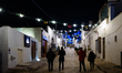 A main street among the trulli of Alberobello decorated for Christmas with very few touris...