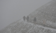 People climbing in foggy weather the Krakus Mound, in Krakow.On Friday, December 11, 2020...
