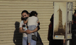 A woman carries a child on the streets of the Zócalo of Mexico City, where a large number...