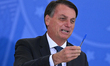 Brazil's President Jair Bolsonaro hods his pen during the swearing-in ceremony of the Braz...