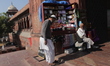 A man without a mask sits outside a mosque on a winter morning, at Jama Masjid, on Decembe...
