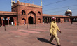 A man wears a mask as a precautionary measure against corona virus inside a mosque on a wi...