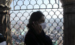 A girl with mask as a precautionary measure against coronavirus inside one of the minarets...
