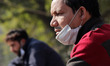 A man wears a protective face mask on his chin, amid the coronavirus disease (COVID-19) ou...