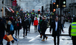 Shoppers, some wearing face masks, walk along a temporarily-pedestrianised Regent Street i...