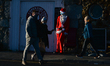 People walking by a Santa wearing a face mask seen in Howth harbour.On Saturday, December...