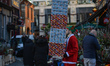 A man carrying boxes with Christmas presents seen on Christmas Eve in Grafton Street, in D...