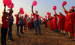 Members of a laughter club practice laughter during Christmas Day celebrations in Mumbai,...