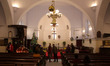 Worshippers visit at the Free Church on the eve of Christmas celebrations, amidst the spre...