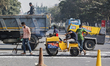 Construction workers installing a speed breaker in Dhaka, Bangladesh on December 26, 2020....