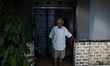 Harry Dalle (73), poses for photograph in front of his house in Bekasi, West Java province...