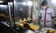 Two Iraqi workers living in Tehran wearing protective face masks cook Arabian fast-food in...