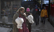 Local Himachali women carry rabbits near Hidimba Temple, Manali, Himachali Pradesh, India,...