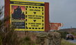 A car passes by a billborad 'Border Communities Against Brexit' located near a former Cust...