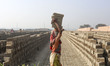 A female brickfield workers is working in brickfields at Narayanganj near Dhaka Bangladesh...