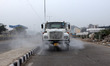 An EDMC truck sprinkles water on the road to curb pollution amid heavy smog, at Anand Viha...