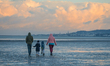 A family enjoys Saturday afternoon walk on Sandymount Strand in Dublin during Level 5 Covi...