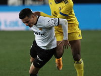 Hugo Guillamon of Valencia and Choco Lozano of Cadiz compete for the ball during the La Liga Santander match between Valencia CF and Cadiz C...