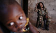Felicia spends time with her youngest son in the house she is building in the familal vill...