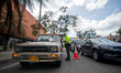 Police officers make controls to prevent people from evading the city wide quarantine afte...
