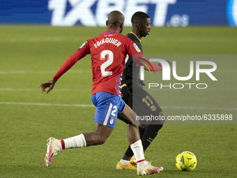 Ousmane Dembele of FC Barcelona in action with Dimitri Foulquier of Granada CF during the La Liga Santander match between Granada CF and FC...