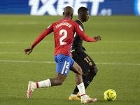 Ousmane Dembele of FC Barcelona in action with Dimitri Foulquier of Granada CF during the La Liga Santander match between Granada CF and FC...