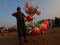 A vendor sells toys at the beach in Mumbai, India on January 10, 2021. (