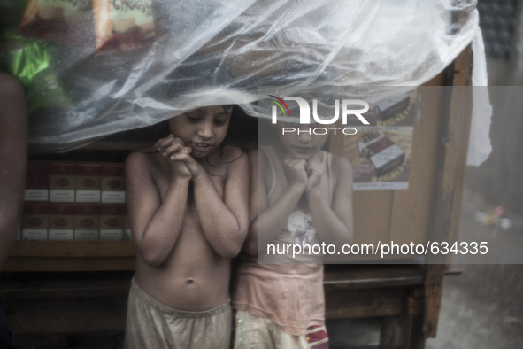 Children during pre monsoon rains in Dhaka, Bangladesh, on June 11, 2015. In last 24 hour more than 100 milimeter rain recorded in different...