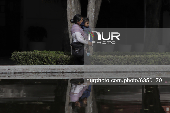 A woman carries her daughter in the exclusive Polanco area of ​​Mexico City, where some restaurants and shops in the area reopened as a form...