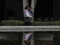 A woman carries her daughter in the exclusive Polanco area of ​​Mexico City, where some restaurants and shops in the area reopened as a form...