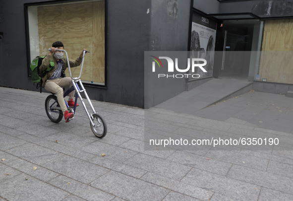 A cyclist in the exclusive Polanco area of ​​Mexico City, where some restaurants and shops in the area reopened their doors as a form of pro...