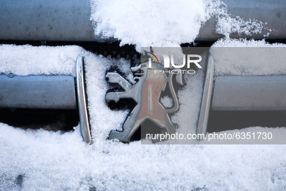 Peugeot car emblem is covered with snow in Krakow, Poland. January 15, 2021. 