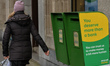 A woman walks by two postal boxes in Rathmnines, Dublin, during Level 5 Covid-19 lockdown....