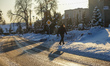 Man walking wih a dog by the pavement covered with a thick layer of snow is seen in Gdansk...